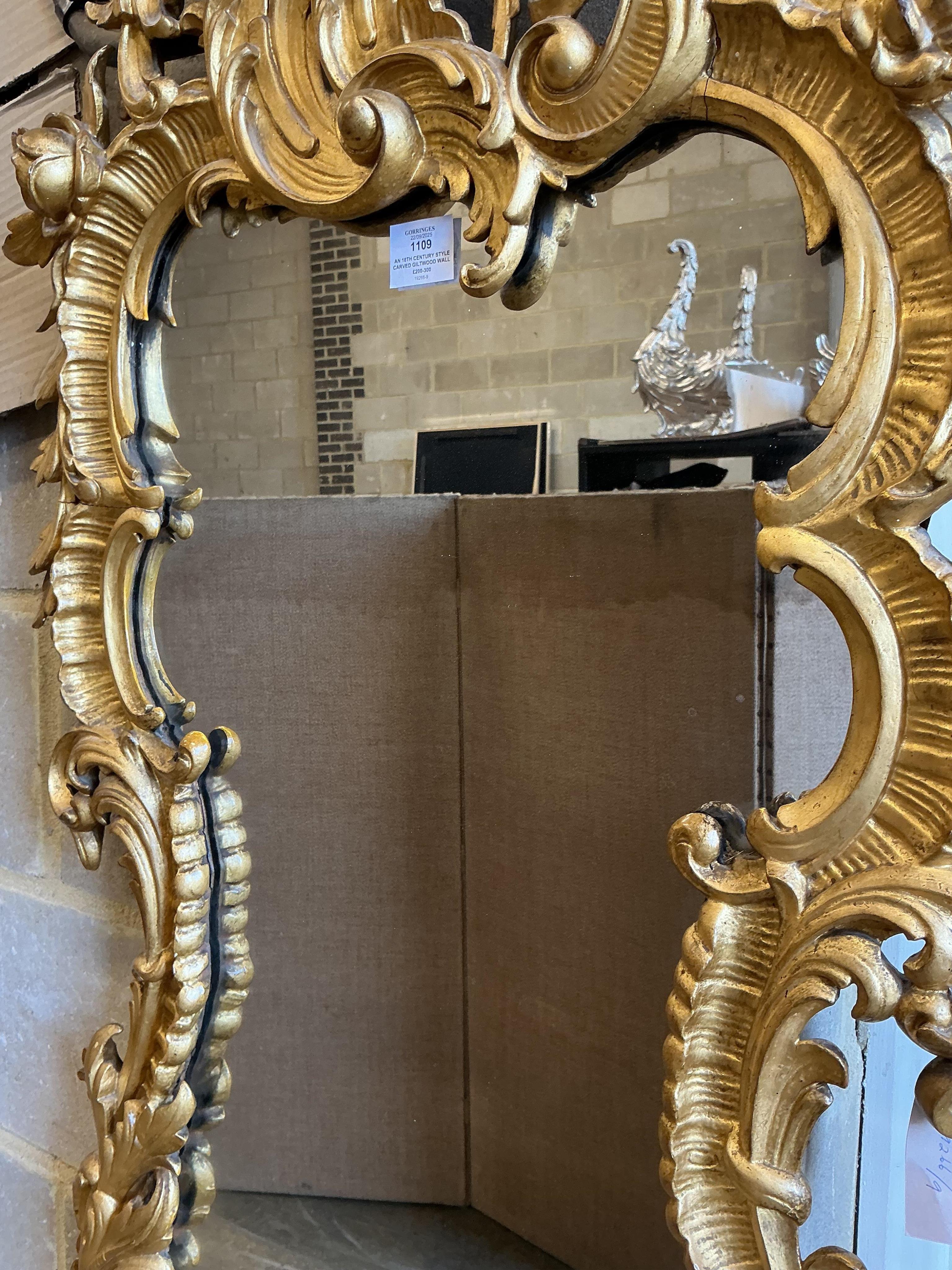 An 18th century style carved giltwood wall mirror, width 64cm, height 128cm
